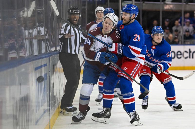 Feb 5, 2024; New York, New York, USA;  New York Rangers center Barclay Goodrow (21) checks Colorado Avalanche left wing Joel Kiviranta (94) during the third period at Madison Square Garden. Mandatory Credit: Dennis Schneidler-USA TODAY Sports