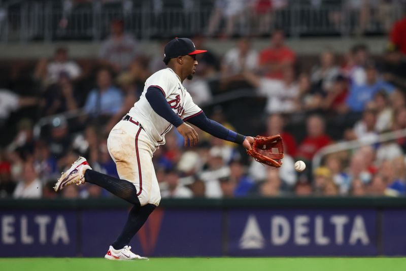 Sep 24, 2024; Atlanta, Georgia, USA; Atlanta Braves second baseman Ozzie Albies (1) tosses the ball to first for an out against the New York Mets in the ninth inning at Truist Park. Mandatory Credit: Brett Davis-Imagn Images
