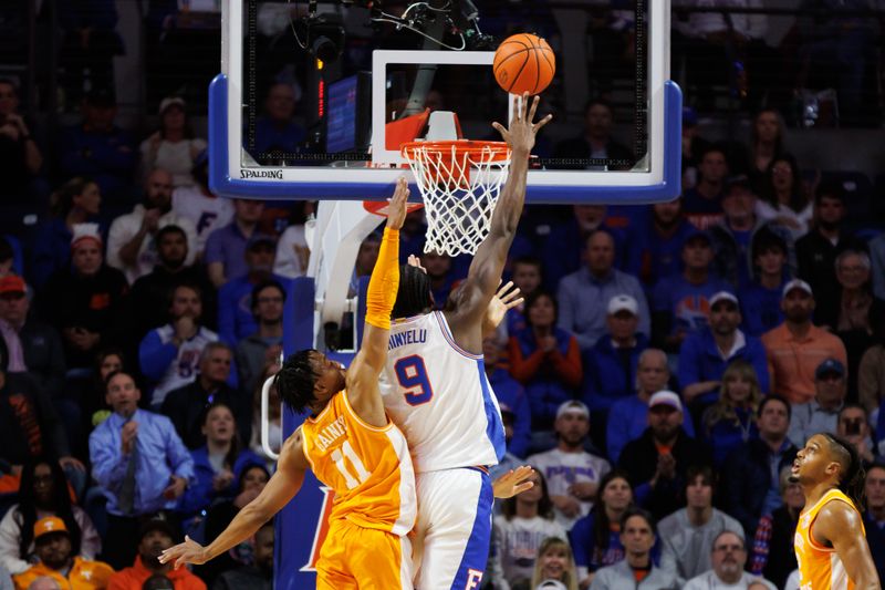 Jan 7, 2025; Gainesville, Florida, USA; Florida Gators center Rueben Chinyelu (9) makes a layup over Tennessee Volunteers guard Jordan Gainey (11) during the first half at Exactech Arena at the Stephen C. O'Connell Center. Mandatory Credit: Matt Pendleton-Imagn Images