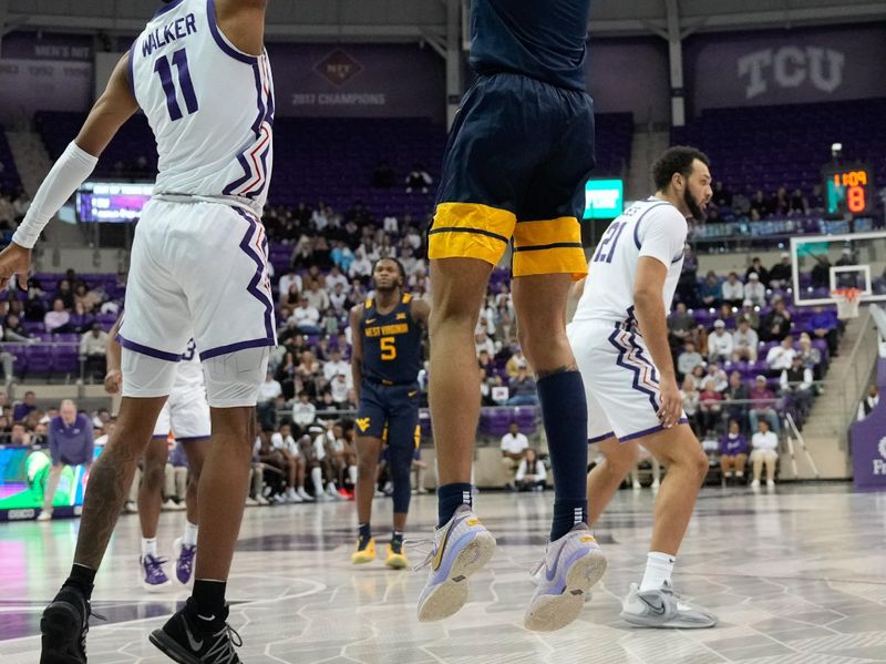 Jan 31, 2023; Fort Worth, Texas, USA; West Virginia Mountaineers forward Emmitt Matthews Jr. (1) scores a three-point basket over TCU Horned Frogs guard Rondel Walker (11) during the second half at Ed and Rae Schollmaier Arena. Mandatory Credit: Chris Jones-USA TODAY Sports