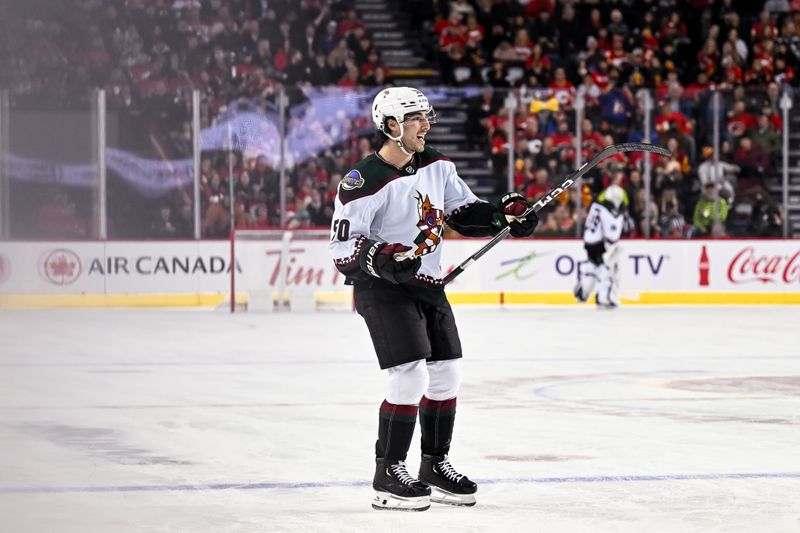 Jan 16, 2024; Calgary, Alberta, CAN; Arizona Coyotes defenseman Sean Durzi (50) celebrates after scoring a goal against the Calgary Flames during the second period at Scotiabank Saddledome. Mandatory Credit: Brett Holmes-USA TODAY Sports