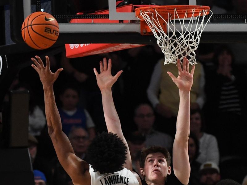 Mar 9, 2024; Nashville, Tennessee, USA; Vanderbilt Commodores guard Tyrin Lawrence (0) scores the game winning basket against Florida Gators forward Alex Condon (21) during the second half at Memorial Gymnasium. Mandatory Credit: Christopher Hanewinckel-USA TODAY Sports