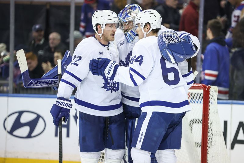 Feb 28, 2025; New York, New York, USA;  Toronto Maple Leafs goaltender Anthony Stolarz (41) celebrates with defenseman Jake McCabe (22) and center David Kampf (64) after defeating the New York Rangers at Madison Square Garden. Mandatory Credit: Wendell Cruz-Imagn Images