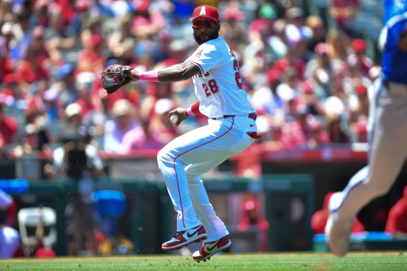 May 12, 2024; Anaheim, California, USA; Los Angeles Angels first baseman Niko Goodrum (28) is late on the throw to first for the attempted out against Kansas City Royals left fielder Dairon Blanco (44) during the fourth inning at Angel Stadium. Mandatory Credit: Gary A. Vasquez-USA TODAY Sports