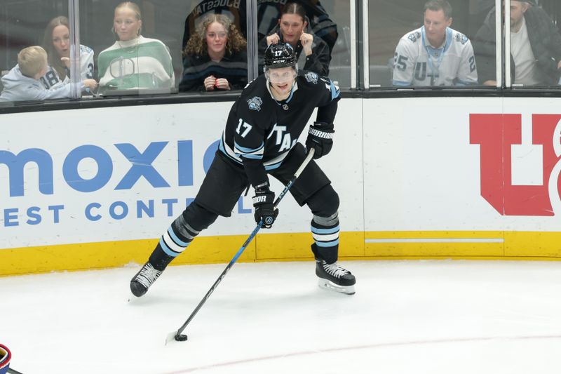 Jan 14, 2025; Salt Lake City, Utah, USA;  Utah Hockey Club center Nick Bjugstad (17) controls the puck against the Montreal Canadiens during the second period at Delta Center. Mandatory Credit: Chris Nicoll-Imagn Images