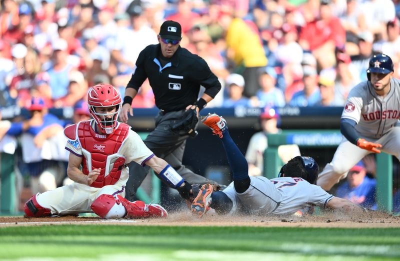 Aug 28, 2024; Philadelphia, Pennsylvania, USA; Houston Astros infielder Jose Altuve (27) slides past Philadelphia Phillies catcher Garrett Stubbs (21) to score in the first inning at Citizens Bank Park. Mandatory Credit: Kyle Ross-USA TODAY Sports