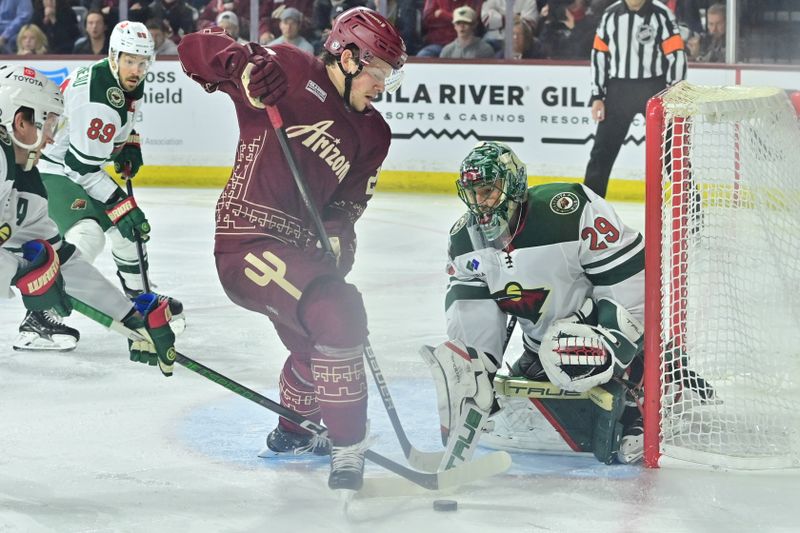 Mar 7, 2024; Tempe, Arizona, USA; Arizona Coyotes center Barrett Hayton (29) and Minnesota Wild goaltender Marc-Andre Fleury (29) battle for the puck in the second period at Mullett Arena. Mandatory Credit: Matt Kartozian-USA TODAY Sports