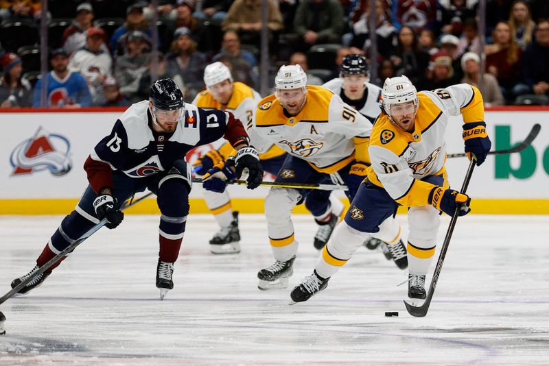 Dec 14, 2024; Denver, Colorado, USA; Nashville Predators center Jonathan Marchessault (81) controls the puck ahead of center Steven Stamkos (91) and Colorado Avalanche right wing Valeri Nichushkin (13) in the first period at Ball Arena. Mandatory Credit: Isaiah J. Downing-Imagn Images