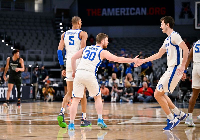 Mar 11, 2023; Fort Worth, TX, USA; Memphis Tigers forward Kaodirichi Akobundu-Ehiogu (5) and guard Conor Glennon (30) and forward Ian Granja (14) celebrate during the second half against the Tulane Green Wave at Dickies Arena. Mandatory Credit: Jerome Miron-USA TODAY Sports