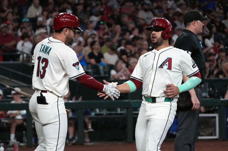 Apr 27, 2025; Phoenix, Arizona, USA; Arizona Diamondbacks third base Eugenio Suárez (28) celebrates with second base Tim Tawa (13) after scoring a run against the Atlanta Braves in the second inning at Chase Field. Mandatory Credit: Rick Scuteri-Imagn Images