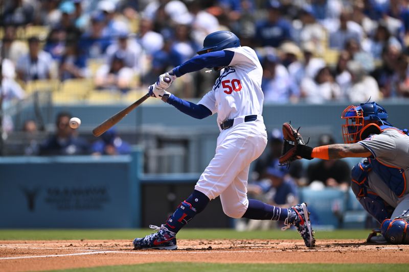 Apr 20, 2024; Los Angeles, California, USA; Los Angeles Dodgers shortstop Mookie Betts (50) doubles against the New York Mets during the first inning at Dodger Stadium. Mandatory Credit: Jonathan Hui-USA TODAY Sports