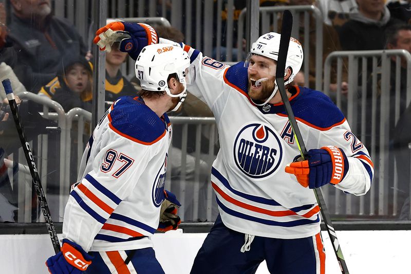 Mar 5, 2024; Boston, Massachusetts, USA; Edmonton Oilers center Leon Draisaitl (29) celebrates his game winning overtime goal with teammate center Connor McDavid (97) against the Boston Bruins at TD Garden. Mandatory Credit: Winslow Townson-USA TODAY Sports