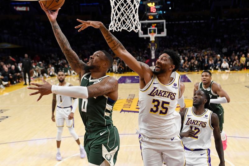 LOS ANGELES, CALIFORNIA - OCTOBER 15: Damian Lillard #0 of the Milwaukee Bucks drives to the basket against Christian Wood #35 of the Los Angeles Lakers during the first half of a preseason basketball game at Crypto.com Arena on October 15, 2023 in Los Angeles, California. NOTE TO USER: User expressly acknowledges and agrees that, by downloading and or using this photograph, User is consenting to the terms and conditions of the Getty Images License Agreement. (Photo by Kevork Djansezian/Getty Images)