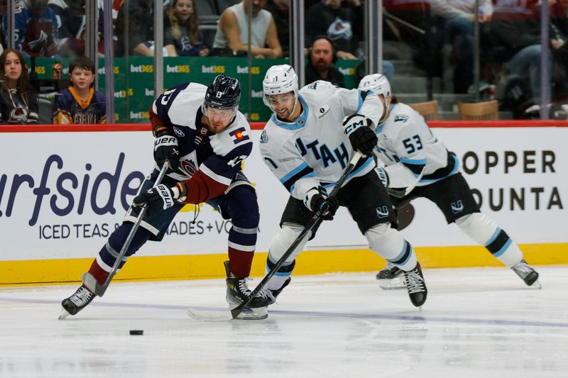 Dec 23, 2025; Denver, Colorado, USA; Colorado Avalanche right wing Valeri Nichushkin (13) controls the puck ahead of Utah Mammoth right wing Dylan Guenther (11) in the first period at Ball Arena. Mandatory Credit: Isaiah J. Downing-Imagn Images