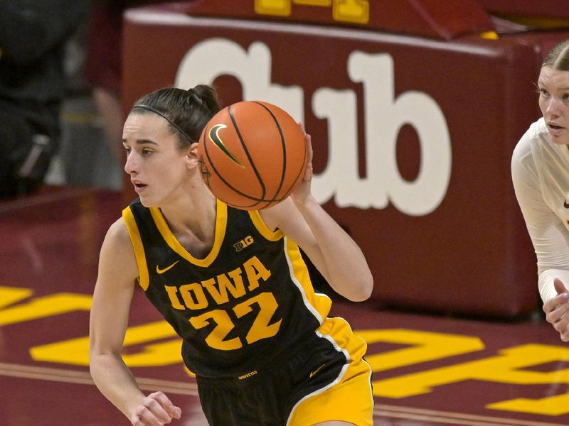 Feb 28, 2024; Minneapolis, Minnesota, USA; Iowa Hawkeyes guard Caitlin Clark (22) brings the ball up-court against the Minnesota Golden Gophers during the first quarter at Williams Arena. Mandatory Credit: Nick Wosika-USA TODAY Sports