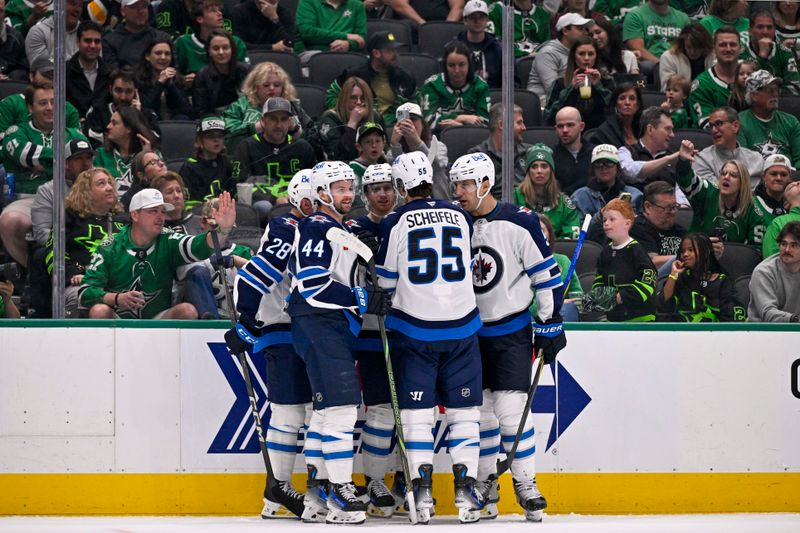 Apr 10, 2025; Dallas, Texas, USA; Winnipeg Jets center Jaret Anderson-Dolan (28) and defenseman Josh Morrissey (44) and center Mark Scheifele (55) and defenseman Luke Schenn (5) celebrates a goal scored by left wing Kyle Connor (81) against the Dallas Stars during the third period at the American Airlines Center. Mandatory Credit: Jerome Miron-Imagn Images