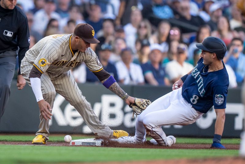 Aug 8, 2023; Seattle, Washington, USA; Seattle Mariners left fielder Dominic Canzone (8) steals third base after San Diego Padres third baseman Manny Machado (13) is unable to make a tag during the third inning at T-Mobile Park. Mandatory Credit: Stephen Brashear-USA TODAY Sports