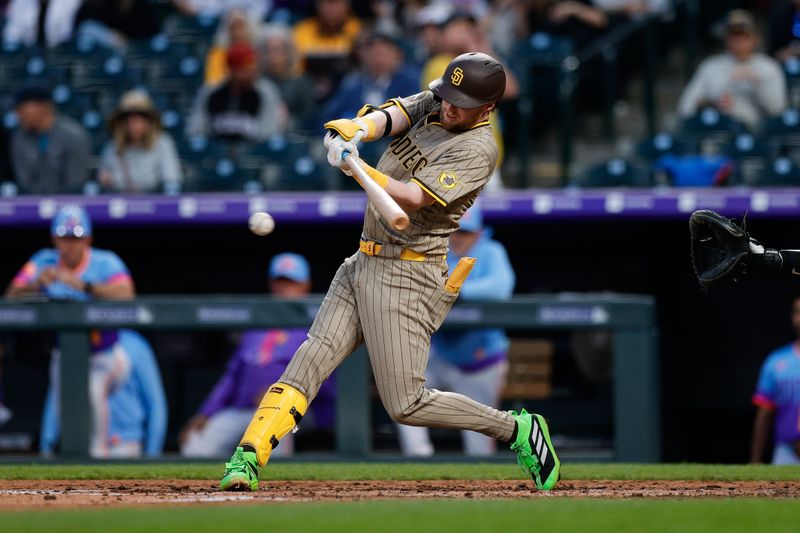 May 9, 2025; Denver, Colorado, USA; San Diego Padres second baseman Jake Cronenworth (9) hits into a fielders choice RBI on a throwing error from the Colorado Rockies in the fifth inning at Coors Field. Mandatory Credit: Isaiah J. Downing-Imagn Images