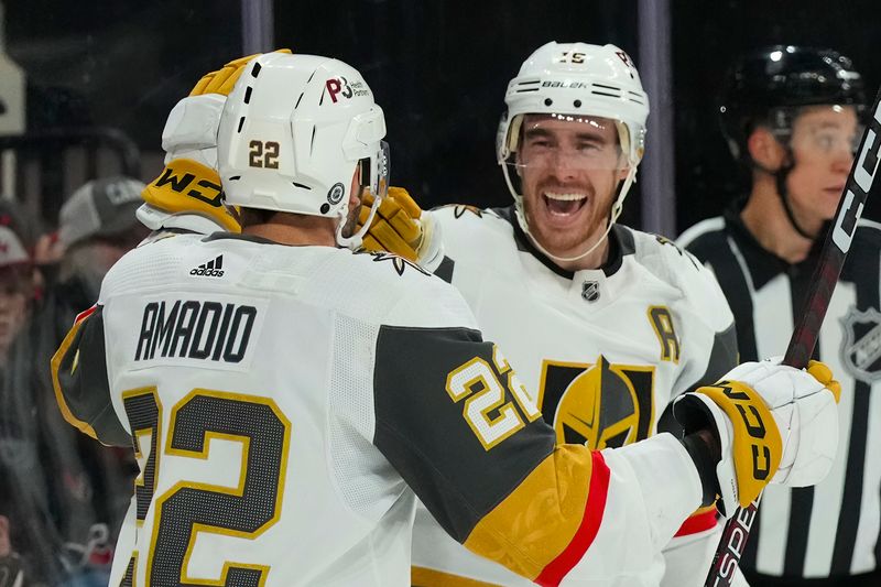 Mar 11, 2023; Raleigh, North Carolina, USA;  Vegas Golden Knights right wing Reilly Smith (19) is congratulated by  right wing Michael Amadio (22) after his goal against the Carolina Hurricanes during the second period at PNC Arena. Mandatory Credit: James Guillory-USA TODAY Sports