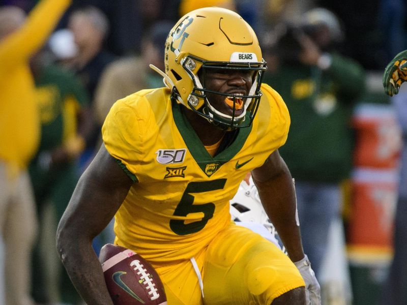 Nov 23, 2019; Waco, TX, USA; Baylor Bears wide receiver Denzel Mims (5) celebrates catching a touchdown pass in front of Texas Longhorns defensive back D'Shawn Jamison (5) during the game at McLane Stadium. Mandatory Credit: Jerome Miron-USA TODAY Sports