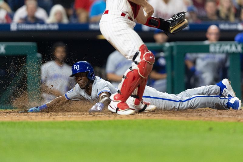 Aug 4, 2023; Philadelphia, Pennsylvania, USA; Kansas City Royals second baseman Samad Taylor (0) slides into home past Philadelphia Phillies catcher J.T. Realmuto (10) for a run during the eighth inning at Citizens Bank Park. Mandatory Credit: Bill Streicher-USA TODAY Sports