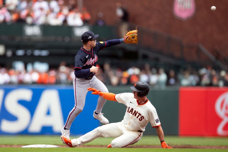 Jun 8, 2025; San Francisco, California, USA; San Francisco Giants third baseman Matt Chapman (26) slips safely into second base with a double ahead of the relay to Atlanta Braves shortstop Nick Allen (2) during the second inning at Oracle Park. Mandatory Credit: D. Ross Cameron-Imagn Images