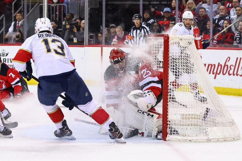 Jan 14, 2025; Newark, New Jersey, USA; Florida Panthers center Sam Reinhart (13) snows New Jersey Devils goaltender Jacob Markstrom (25) during the third period at Prudential Center. Mandatory Credit: Ed Mulholland-Imagn Images