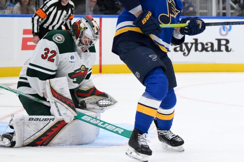 Oct 15, 2024; St. Louis, Missouri, USA; Minnesota Wild goaltender Filip Gustavsson (32) makes a save against the St. Louis Blues during the second period at Enterprise Center. Mandatory Credit: Jeff Le-Imagn Images