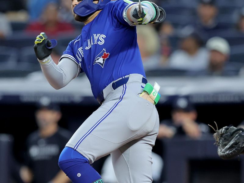 Sep 5, 2025; Bronx, New York, USA; Toronto Blue Jays shortstop Bo Bichette (11) follows through on a broken bat RBI double against the New York Yankees during the first inning at Yankee Stadium. Mandatory Credit: Brad Penner-Imagn Images