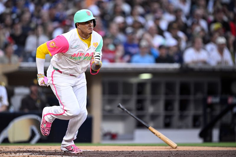 Jul 12, 2024; San Diego, California, USA; San Diego Padres third baseman Manny Machado (13) hits an RBI double against the Atlanta Braves during the fourth inning at Petco Park. Mandatory Credit: Orlando Ramirez-USA TODAY Sports 