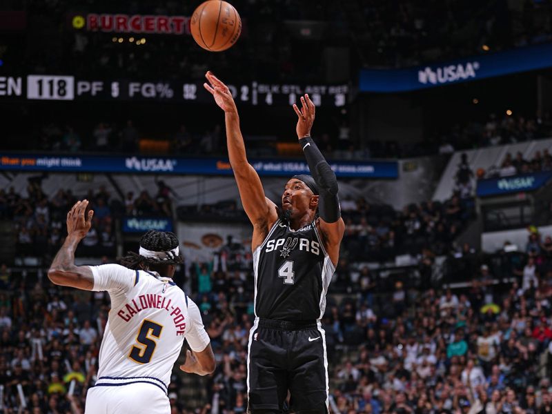 SAN ANTONIO, TX - APRIL 12: Devonte Graham #4 of the San Antonio Spurs shoots a three point basket during the game against the Denver Nuggets on April 12, 2024 at the Frost Bank Center in San Antonio, Texas. NOTE TO USER: User expressly acknowledges and agrees that, by downloading and or using this photograph, user is consenting to the terms and conditions of the Getty Images License Agreement. Mandatory Copyright Notice: Copyright 2024 NBAE (Photos by Garrett Ellwood/NBAE via Getty Images)