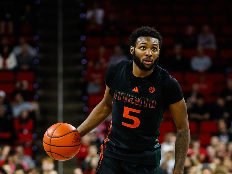 Jan 30, 2024; Raleigh, North Carolina, USA; Miami (Fl) Hurricanes guard Wooga Poplar (5) dribbles with the ball during the second half against North Carolina State Wolfpack at PNC Arena. Mandatory Credit: Jaylynn Nash-USA TODAY Sports