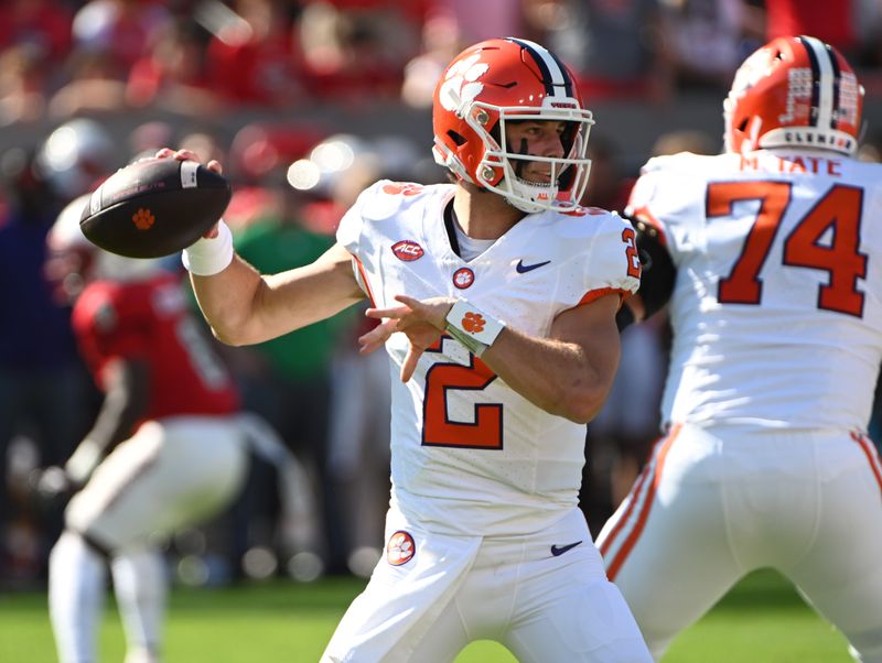 Oct 28, 2023; Raleigh, North Carolina, USA; Clemson Tigers quarterback Cade Klubnik (2) throws a pass during the first half against the North Carolina State Wolfpack at Carter-Finley Stadium. Mandatory Credit: Rob Kinnan-USA TODAY Sports