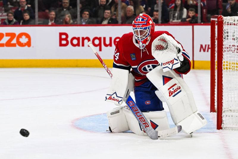 Dec 2, 2023; Montreal, Quebec, CAN; Montreal Canadiens goalie Jake Allen (34) tracks the puck against the Detroit Red Wings during the second period at Bell Centre. Mandatory Credit: David Kirouac-USA TODAY Sports