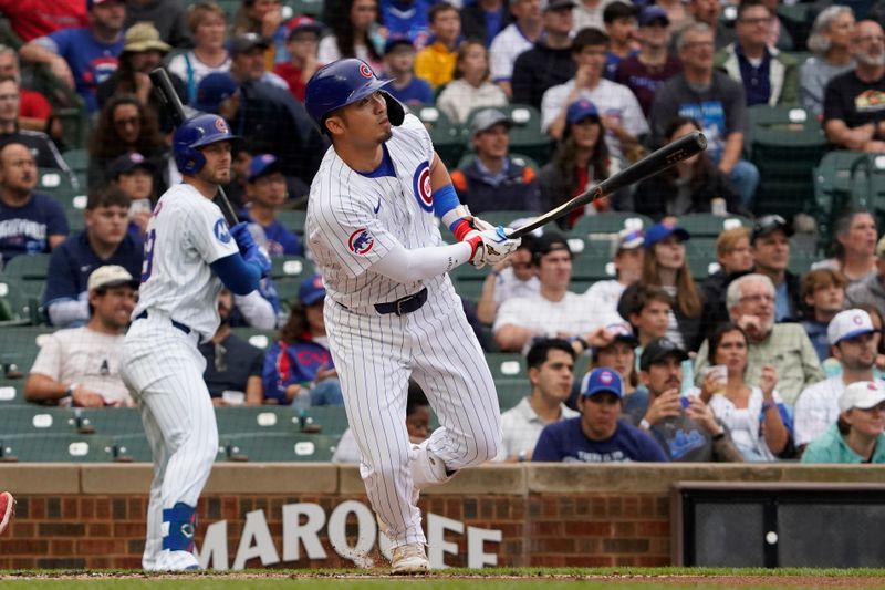 Sep 22, 2024; Chicago, Illinois, USA; Chicago Cubs outfielder Seiya Suzuki (27) hits a one run single against the Washington Nationals during the first inning at Wrigley Field. Mandatory Credit: David Banks-Imagn Images