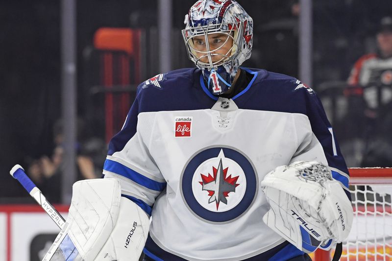 Mar 6, 2025; Philadelphia, Pennsylvania, USA; Winnipeg Jets goaltender Eric Comrie (1) against the Philadelphia Flyers at Wells Fargo Center. Mandatory Credit: Eric Hartline-Imagn Images