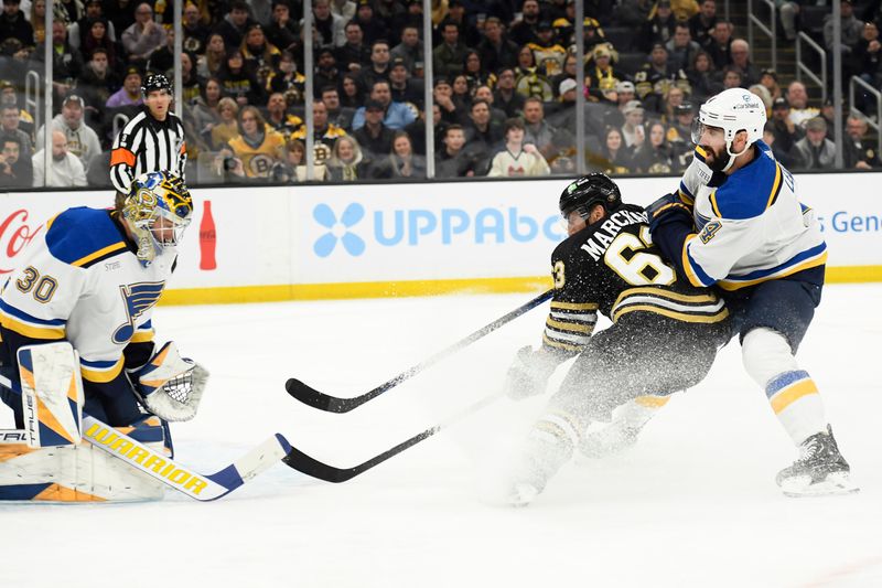 Mar 11, 2024; Boston, Massachusetts, USA; St. Louis Blues goaltender Joel Hofer (30) makes a save on Boston Bruins left wing Brad Marchand (63) while St. Louis Blues defenseman Nick Leddy (4) defends during the first period at TD Garden. Mandatory Credit: Bob DeChiara-USA TODAY Sports