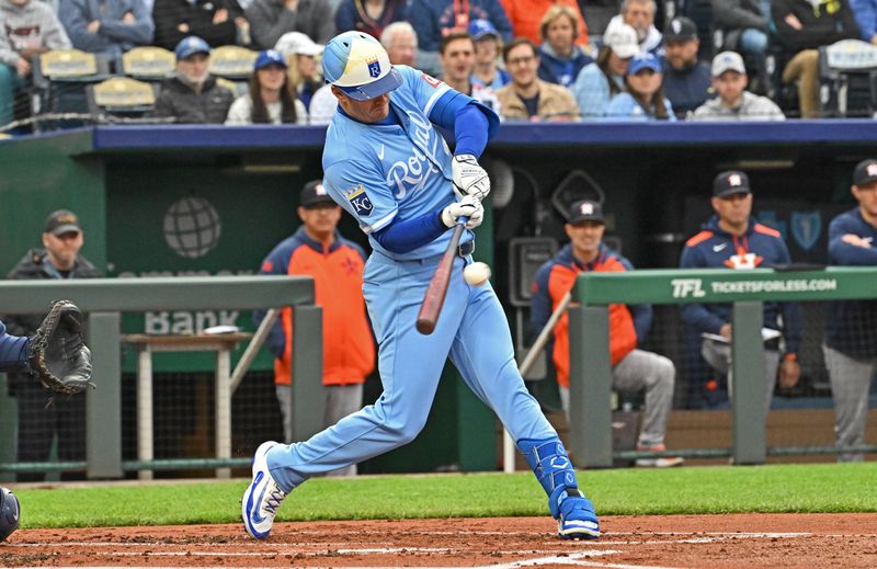 Apr 26, 2025; Kansas City, Missouri, USA;  Kansas City Royals left fielder Mark Canha (21) drives in a run with a sacrifice fly in the first inning against the Houston Astros at Kauffman Stadium. Mandatory Credit: Peter Aiken-Imagn Images