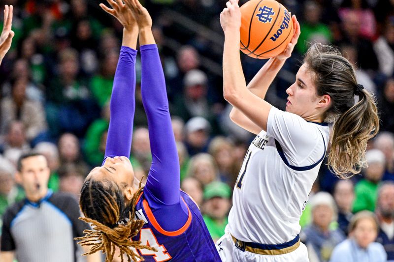 Feb 22, 2024; South Bend, Indiana, USA; Notre Dame Fighting Irish guard Sonia Citron (11) looks to shoot as Clemson Tigers forward Amani Freeman (34) defends in the second half at the Purcell Pavilion. Mandatory Credit: Matt Cashore-USA TODAY Sports