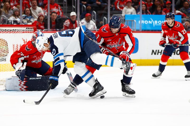 Mar 24, 2024; Washington, District of Columbia, USA; Washington Capitals defenseman Nick Jensen (3) battles for the puck with Winnipeg Jets right wing Nino Niederreiter (62) in front of Capitals goaltender Charlie Lindgren (79) during the second period at Capital One Arena. Mandatory Credit: Amber Searls-USA TODAY Sports