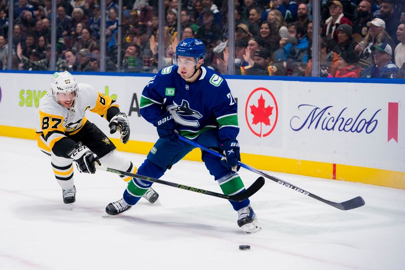 Feb 27, 2024; Vancouver, British Columbia, CAN; Pittsburgh Penguins forward Sidney Crosby (87) stick checks Vancouver Canucks forward Nils Hoglander (21) in the first period at Rogers Arena. Mandatory Credit: Bob Frid-USA TODAY Sports