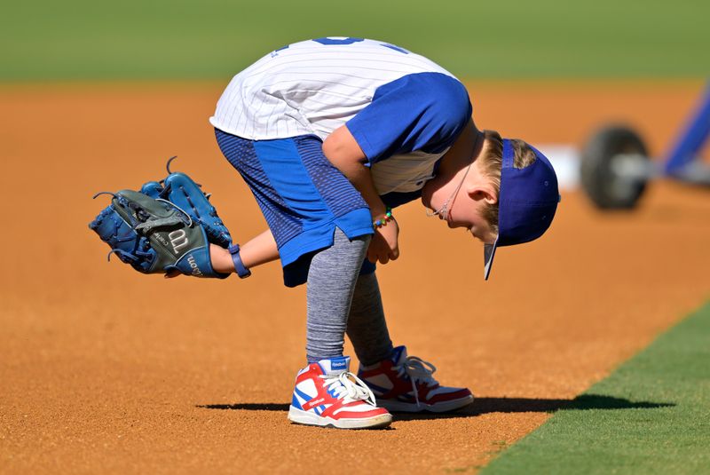 Aug 2, 2023; Los Angeles, California, USA;  Six year old Charley Kershaw plays with his dad, Los Angeles Dodgers starting pitcher Clayton Kershaw (22), on the field prior to the game against the Oakland Athletics at Dodger Stadium. Mandatory Credit: Jayne Kamin-Oncea-USA TODAY Sports