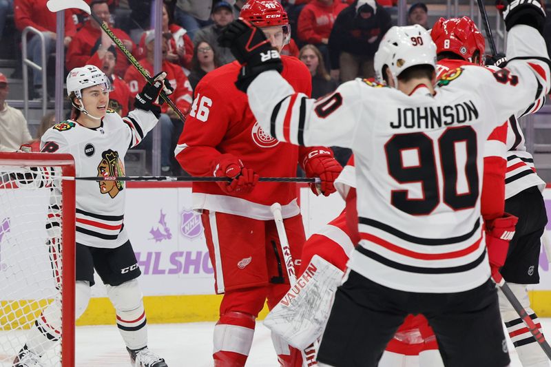 Nov 30, 2023; Detroit, Michigan, USA;  Chicago Blackhawks center Connor Bedard (98) and center Tyler Johnson (90) celebrate a goal by left wing Lukas Reichel (not pictured) in the first period against the Detroit Red Wings at Little Caesars Arena. Mandatory Credit: Rick Osentoski-USA TODAY Sports