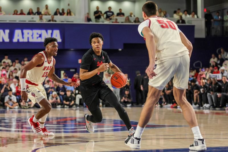 Feb 22, 2024; Boca Raton, Florida, USA; Southern Methodist Mustangs guard Zhuric Phelps (1) drives to the basket past Florida Atlantic Owls guard Brandon Weatherspoon (23) during the first half at Eleanor R. Baldwin Arena. Mandatory Credit: Sam Navarro-USA TODAY Sports