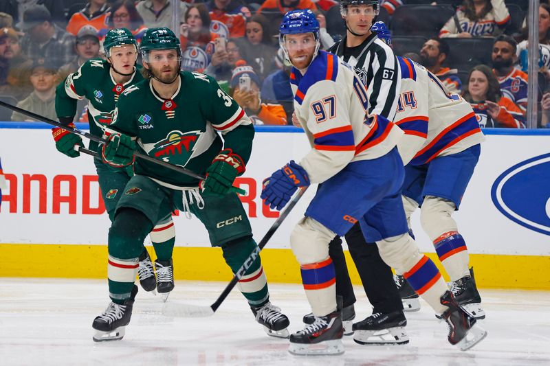 Jan 31, 2026; Edmonton, Alberta, CAN; .Minnesota Wild forward Ryan Hartman (38) and Edmonton Oilers forward Connor McDavid (97) looks for a loose puck during the second period at Rogers Place. Mandatory Credit: Perry Nelson-Imagn Images