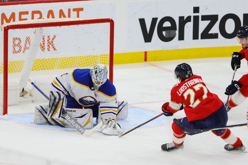 Apr 13, 2024; Sunrise, Florida, USA; Florida Panthers center Eetu Luostarinen (27) controls the puck against Buffalo Sabres goaltender Ukko-Pekka Luukkonen (1) during the third period at Amerant Bank Arena. Mandatory Credit: Sam Navarro-USA TODAY Sports