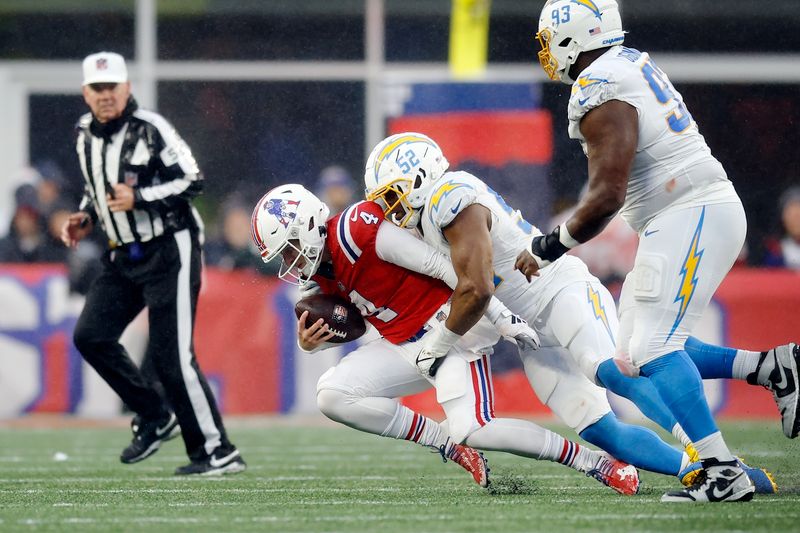 Los Angeles Chargers linebacker Khalil Mack (52) tackles New England Patriots quarterback Bailey Zappe (4) during the second half of an NFL football game, Sunday, Dec. 3, 2023, in Foxborough, Mass. (AP Photo/Michael Dwyer)