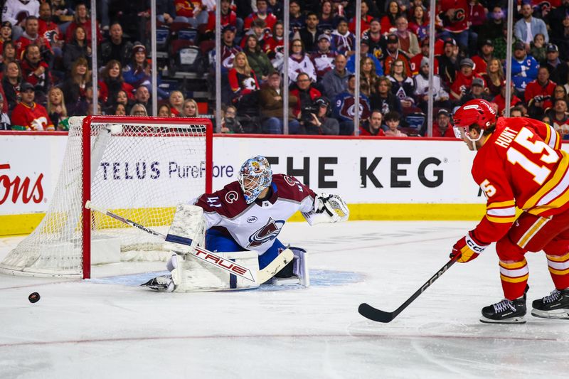 Mar 14, 2025; Calgary, Alberta, CAN; Colorado Avalanche goaltender Scott Wedgewood (41) makes a save against Calgary Flames left wing Dryden Hunt (15) during the second period at Scotiabank Saddledome. Mandatory Credit: Sergei Belski-Imagn Images