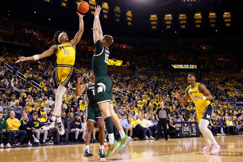 Feb 18, 2023; Ann Arbor, Michigan, USA;  Michigan Wolverines guard Kobe Bufkin (2) shoots the ball against Michigan State Spartans center Carson Cooper (15) in the first half at Crisler Center. Mandatory Credit: Rick Osentoski-USA TODAY Sports