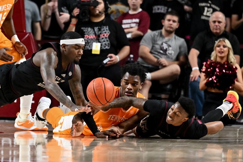 Feb 21, 2023; College Station, Texas, USA;  Texas A&M Aggies guard Wade Taylor IV (4), guard Tyrece Radford (23) and Tennessee Volunteers forward Tobe Awaka (11) dive for a loose during the second half at Reed Arena. Mandatory Credit: Maria Lysaker-USA TODAY Sports